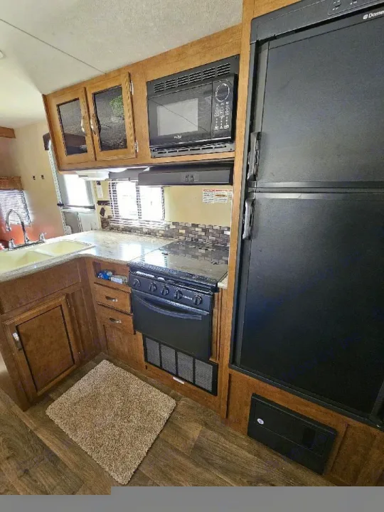 RV rental kitchen: Microwave, stove, refrigerator, and sink. Complete cooking setup for your next adventure.. Forest River Salem Cruise Lite 2017