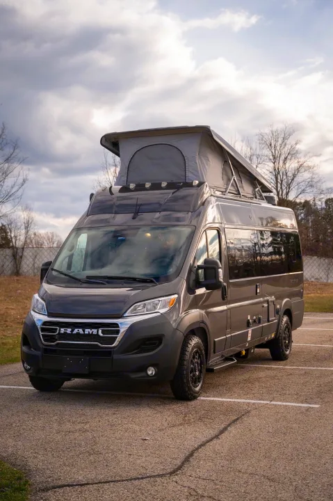 Explore with this dark gray RAM camper van featuring a deployed pop-top tent. Your next rv rental is ready!. Thor Sequence 2024