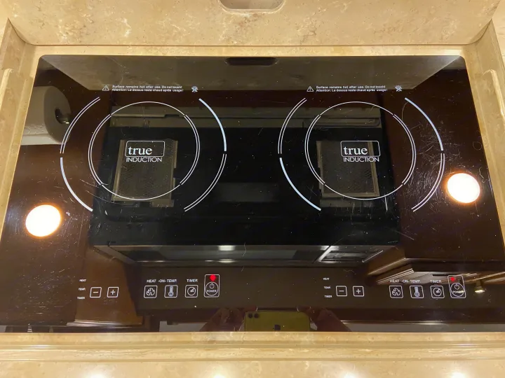 A two-burner "True Induction" cooktop in an RV rental kitchen, with digital controls. An efficient, sleek appliance for travelers.. Tiffin Motorhomes Allegro Bus 2017