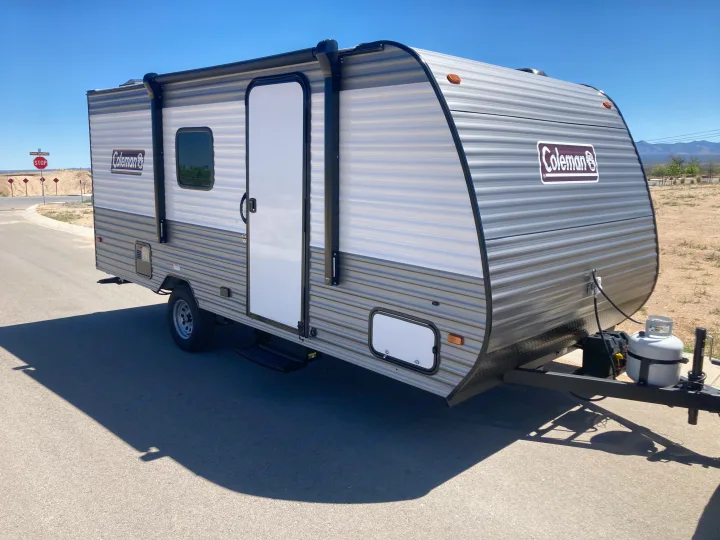 New Coleman RV rental: compact travel trailer parked outdoors on a clear day, ready for adventure.. Coleman Lantern 17B 2024
