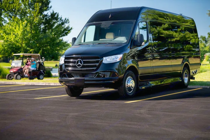Luxury black Mercedes-Benz Sprinter van, perfect for RV rental or executive trips, parked by a golf course.. Mercedes-Benz Sprinter 2024