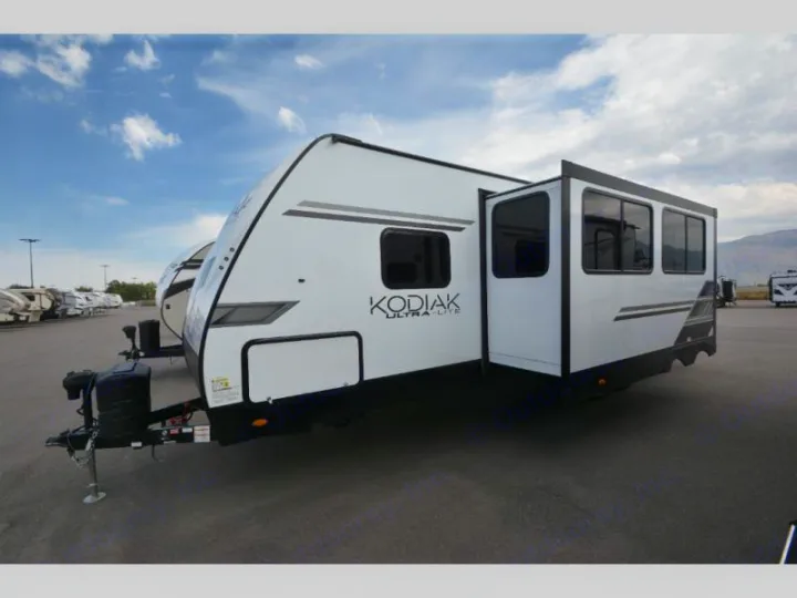 White Kodiak Ultra-Lite travel trailer with an extended slide-out. Perfect for your next RV rental adventure.. Keystone Kodiak 2022