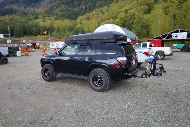 Black 4Runner with iKamper roof tent and dirt bike. An overland setup for adventures beyond typical RV rental.. Toyota Other 2015