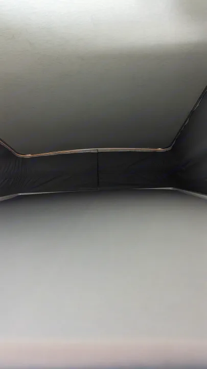 RV rental pop-top view: Raised ceiling, dark fabric walls, and mattress inside a campervan for comfortable travel.. Winnebago Solis 59PX 2023