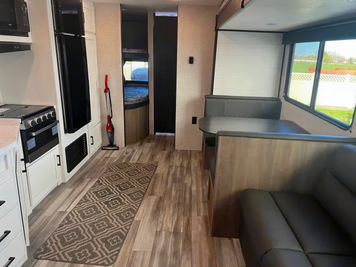 Spacious RV rental interior with a modern kitchen, comfortable dinette, and bunk beds, ideal for family adventures.. Jayco Jayflight 2024