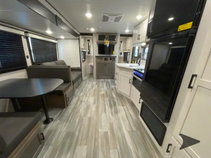 Explore this modern RV rental interior featuring a full kitchen, dinette, and comfortable living space. Ready for your next trip.. Jayco Jayflight 2024