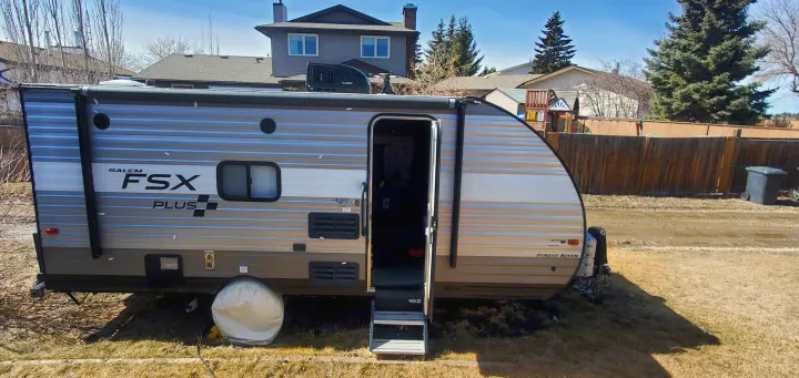 Grey Salem FSX Plus travel trailer with door open, an excellent RV rental option.. Forest River Salem FSX 2019