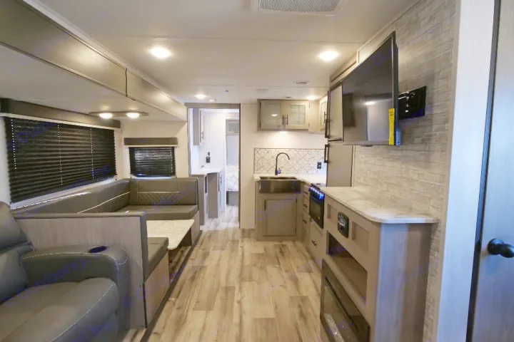 Modern RV rental with a well-equipped kitchen, plush U-shaped dinette, TV, and fireplace.. Dutchmen Coleman Light 2022