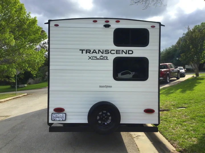 Rear view of a white Grand Design Transcend Xplor recreational vehicle, ideal for your next rv rental.. Grand Design Transcend Xplor 2024