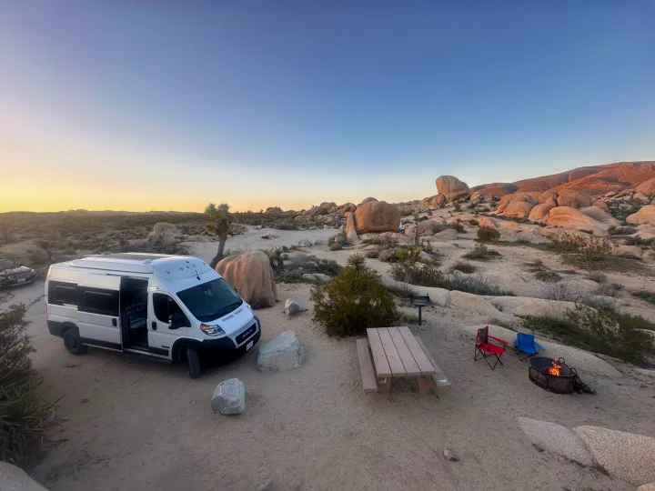 RV rental adventure: Desert camping with a camper van, campfire, and stunning rock formations.. Winnebago Solis 2023