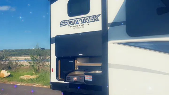 Enjoy this SportTrek RV rental's outdoor kitchen with griddle & sink, perfect for camping by scenic lakes.. Venture STT343VIB 2022