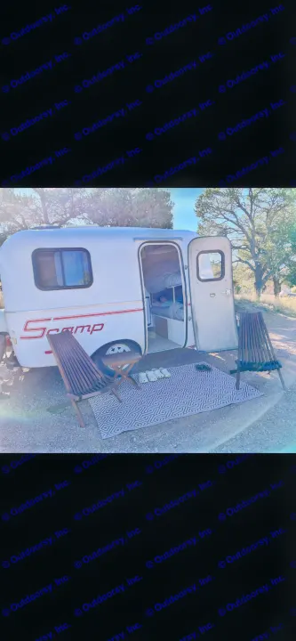 This cozy Scamp travel trailer RV rental features bunk beds, an outdoor rug, chairs & Crocs for a relaxing glamping trip.. Scamp Scamp Trailer 2004