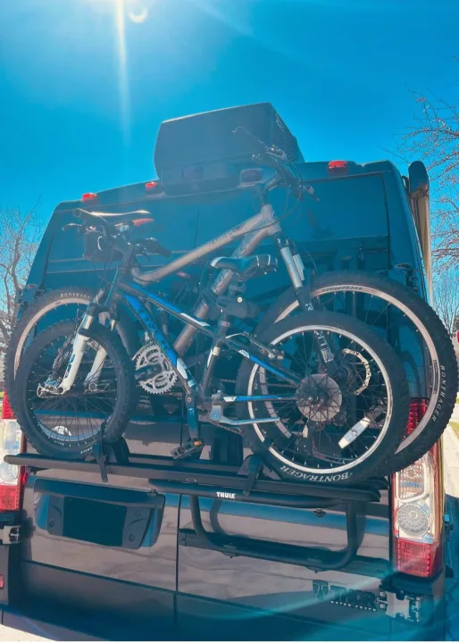 Thor Motor Coach RV rental: a dark camper van with two bikes on a Thule rack, ready for outdoor adventures.. Thor Sequence 2024