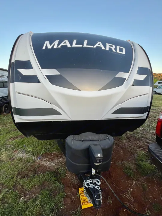 Front view of a white and black Mallard travel trailer, perfect for your next RV rental adventure or camping trip.. Heartland M-3385 2021