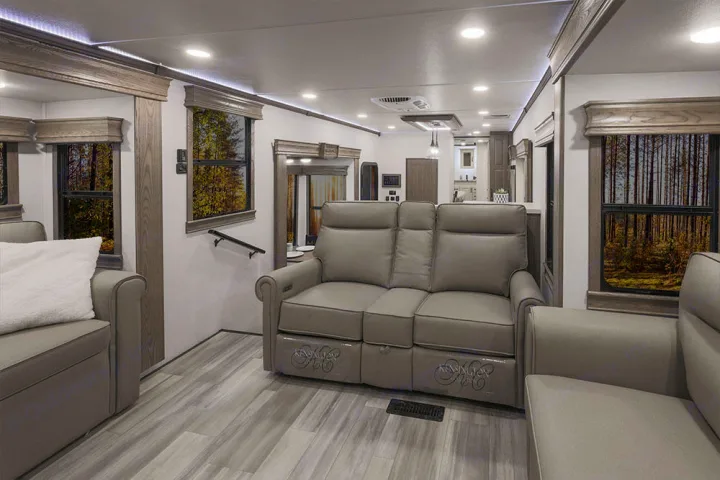 Enjoy a spacious RV rental living area with comfortable recliners, modern design, and beautiful nature views from the windows.. Alliance RV Paradigm 2021