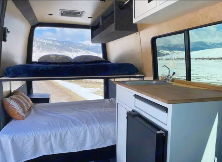 Van life ready! This RV rental features bunk beds, a kitchen, and stunning snowy mountain views.. Vanworks Base Camp 2021