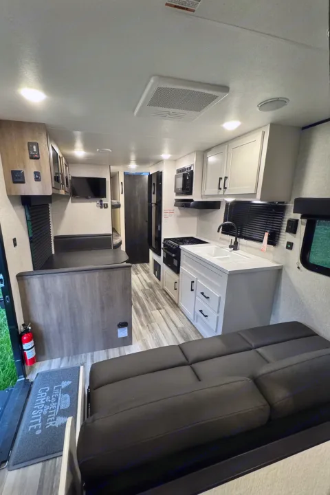 Modern RV rental interior featuring a kitchen, dinette, and sofa bed for your next camping trip.. Jayco Jayflight 2024