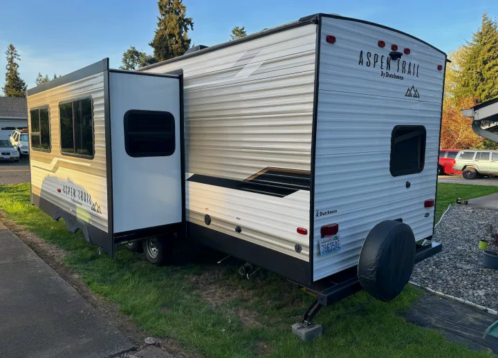 Aspen Trail by Dutchmen RV rental: A white travel trailer with an extended side slide-out, ready for adventure.. Aspen Trail Aspen Trail Trailer 2021