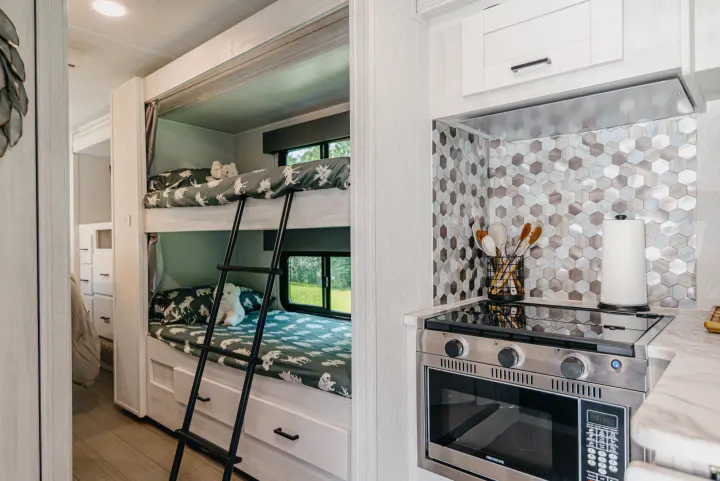 Explore this RV rental's cozy bunk beds & modern kitchen. Perfect for family adventures on the road!. East to West Entrada 2024