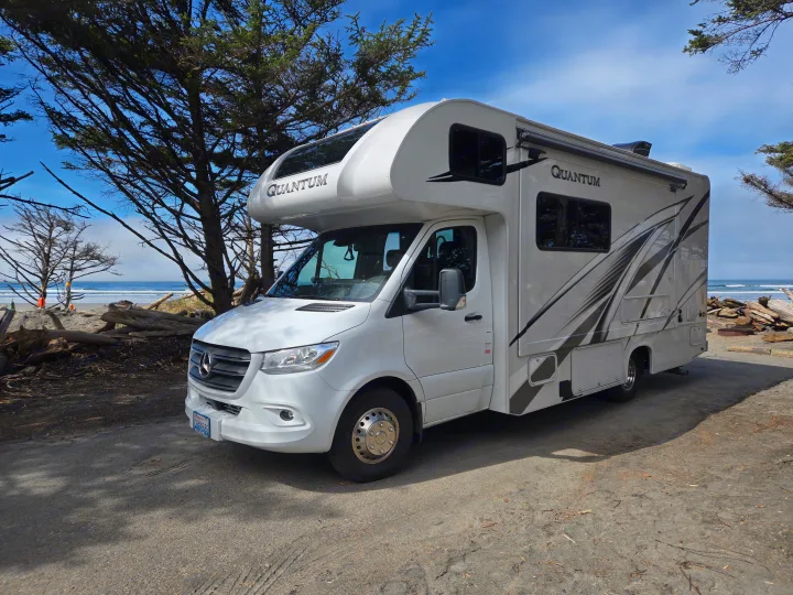 RV rental: White Quantum RV parked on a beach path with ocean views and trees, ready for adventure!. Thor Quantum 2023