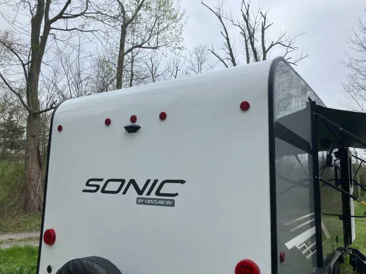 Rear view of a white Sonic RV, ideal for an RV rental adventure. Features lights and backup camera.. Sonic Sonic Trailer 2023