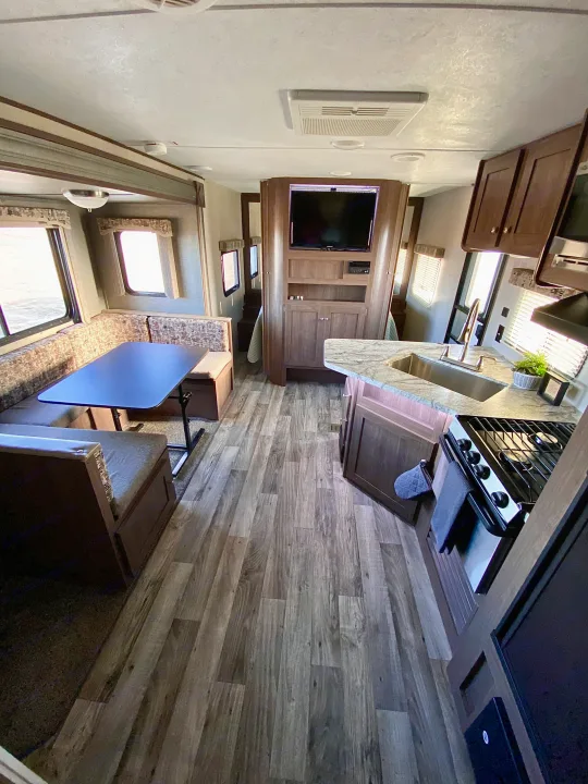 This RV rental features a comfortable dinette, compact kitchen, and entertainment unit, all in a stylish interior.. Keystone RV Hideout 2018