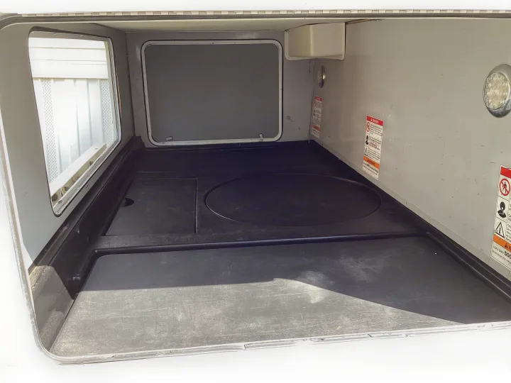 Clean RV rental storage bay, ready for outdoor gear. Features a durable molded floor liner and convenient access panels.. Thor Majestic 2019