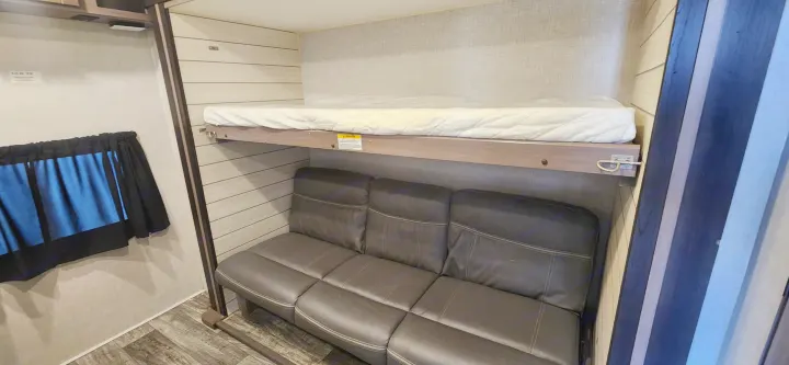 RV rental interior: Comfortable bunk bed over a sofa, perfect for family travel within a compact camper.. Crossroads Sunset Trail 2022