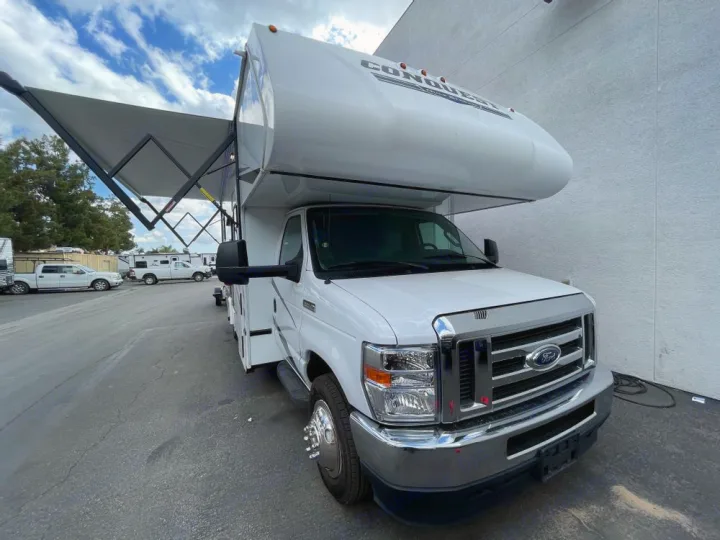 White Ford Conquest Class C RV with extended awning, ready for your next adventure. Check out this RV rental.. Gulf Stream Conquest 2023