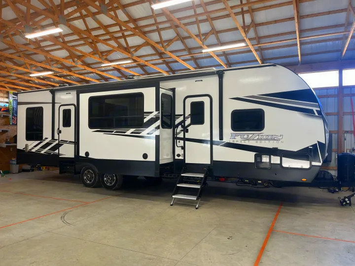 Explore in style! This spacious white & black Fuzion Impact toy hauler RV is perfect for your next RV rental adventure.. Keystone RV Fuzion Impact Toy Hauler 2022