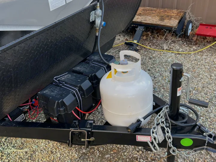 RV rental trailer tongue setup: dual batteries, propane tank, and hitch components. Ready for your next adventure.. Jayco Jay Flight SLX 2023