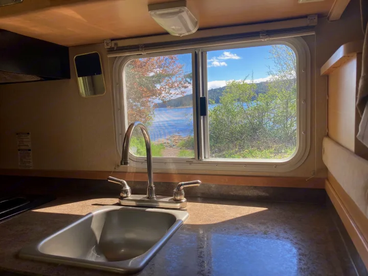 RV rental kitchen sink and window view of a serene lake. A perfect setup for a relaxing travel adventure.. Chevrolet Other 2010
