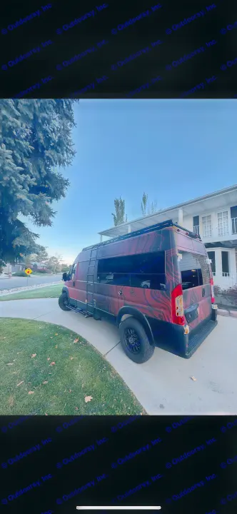A custom dark red and black RV rental van, featuring a swirled design and off-road tires, is parked on a suburban driveway.. Dodge RAM Dodge RAM Promaster 2500 2021