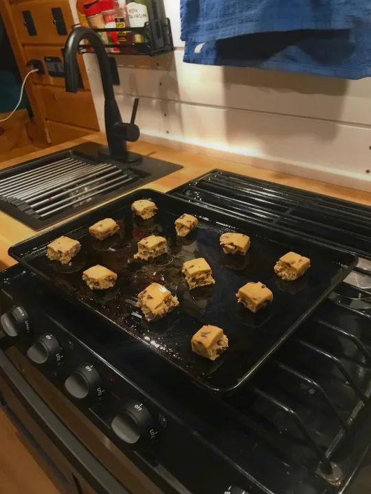 RV rental kitchen: Cookie dough squares on the stove, prepped for delicious baking.. ram promaster 2020
