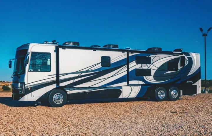 Experience luxury on the open road. This spacious Class A motorhome, perfect for an RV rental adventure, gleams under a blue sky.. Forest River Berkshire 2023