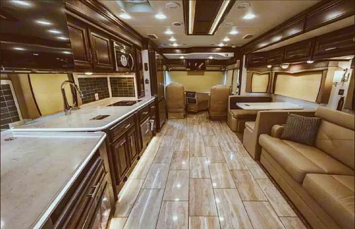 Spacious luxury RV interior with full kitchen, living area, & driver's cockpit. Perfect for an RV rental adventure!. Forest River Berkshire 2023