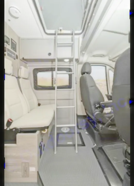 Inside an RV rental van: ladder to a sleeping loft, passenger seating, and front cabin seats. Adventure awaits!. Winnebago Solis PX 2025