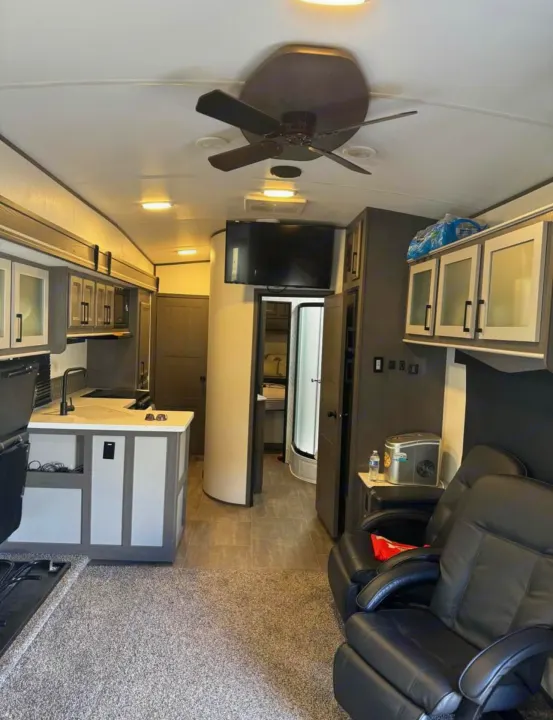 Spacious RV rental interior with kitchen, living area recliners, and a ceiling fan. Great for a comfortable trip.. Cruiser Rv Corp Stryker 2021