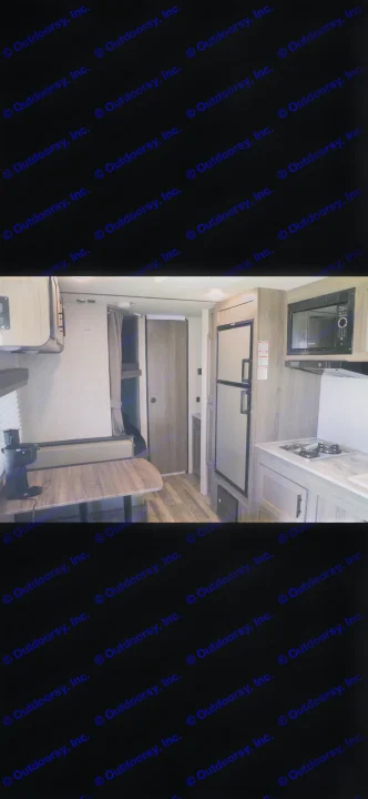 RV rental interior: Kitchenette with fridge & stove, dinette, and bunk beds in a wood-toned space.. Gulf Stream Enlighten 2022