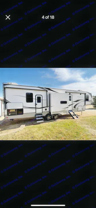 Spacious white fifth-wheel RV rental parked on grass, ready for adventure. Features extendable slide-outs and steps.. Keystone RV Cougar 2021