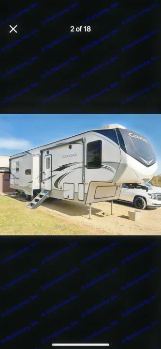 Exterior view of a modern Cougar fifth-wheel RV rental, parked with multiple slide-outs extended.. Keystone RV Cougar 2021