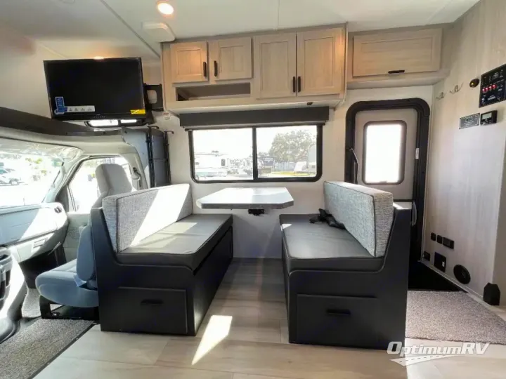 Enjoy this RV rental's spacious dinette area, featuring comfortable benches, overhead storage, and a mounted TV. Perfect for road trips!. Forest River Solera 2024