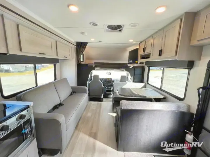 Bright rv rental interior showcasing a sofa, dinette, kitchen, and overhead bunk. Ideal for family road trips.. Forest River Solera 2024