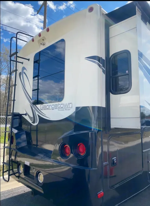This Georgetown Forest River RV rental features a white and black motorhome with a rear ladder, perfect for your next adventure.. Forest River Georgetown 2014