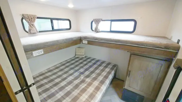 Spacious RV rental bunk beds: L-shaped upper bunks and a lower bed provide ample sleeping space in this RV interior.. Forest River Wildwood 2021