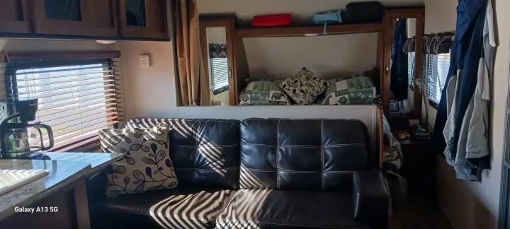 Cozy RV rental interior showcasing comfortable living space, kitchenette, and sleeping area – perfect for road trip adventures.. Forest River Salem Cruise Lite 2018