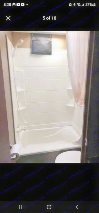 RV rental bathroom with tub/shower, handheld showerhead, built-in shelves, and curtain. Toilet visible.. StarCraft autumn ridge 2014