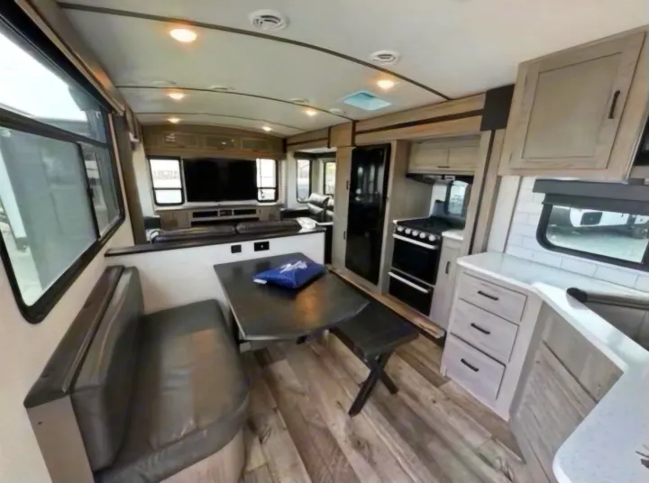 RV rental: Explore this modern interior with a spacious U-shaped dinette, full kitchen, and comfortable living area.. Keystone RV Outback 2021