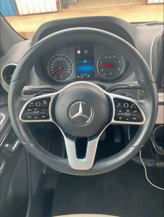Close-up of a modern Mercedes-Benz Sprinter van's dashboard & steering wheel, perfect for an RV rental adventure.. Airstream Interstate 2021