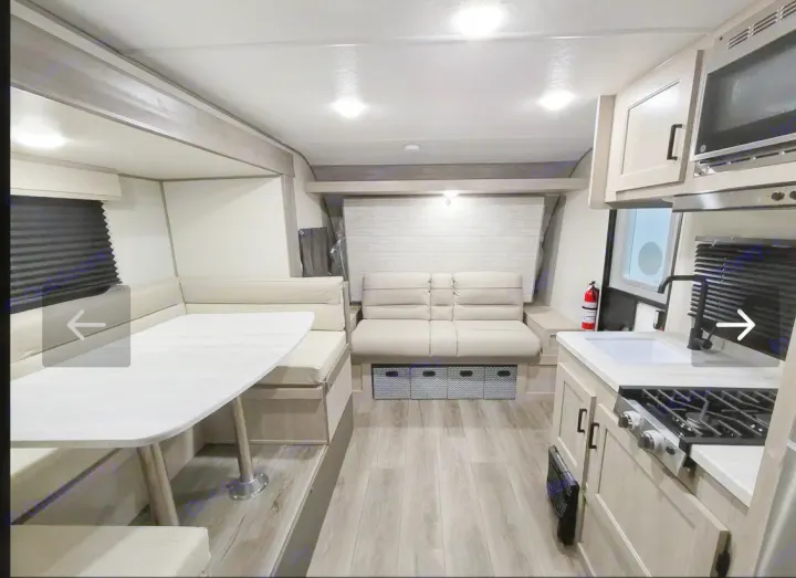 Step inside this modern RV rental, showcasing a full kitchen, dinette, and comfortable seating area.. Coachmen Catalina 2024